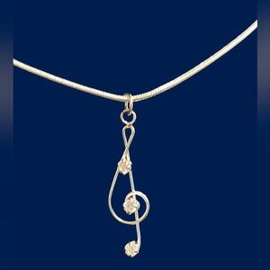 Elegant Silver Treble Clef Necklace with CZ Accents. NWT